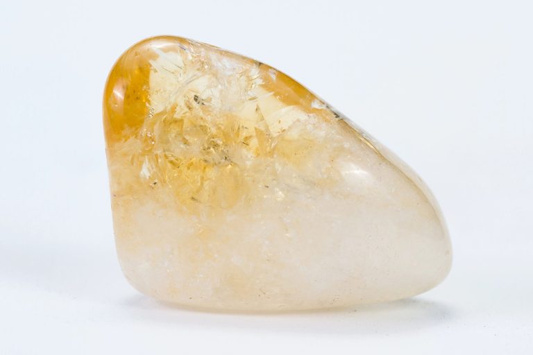 Polished citrine crystal on white background