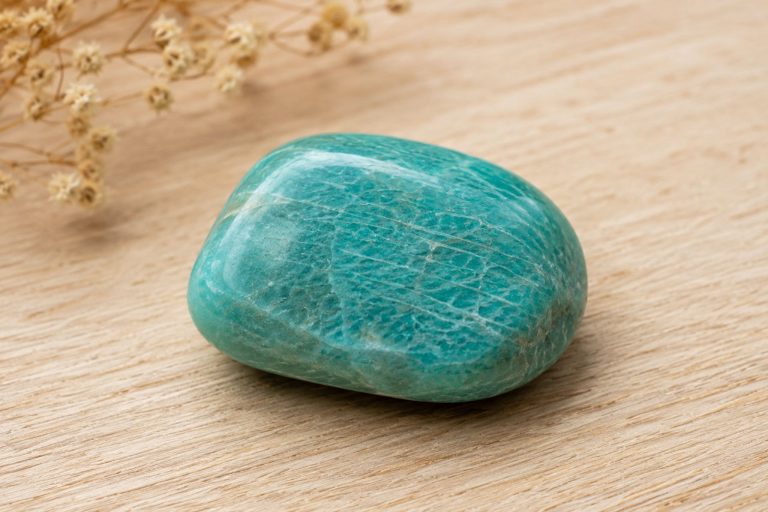 Turquoise amazonite on wooden surface for wellness and energy.