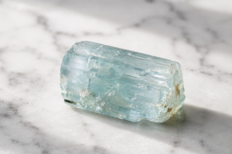 Aquamarine crystal from Crystalance on marble surface.