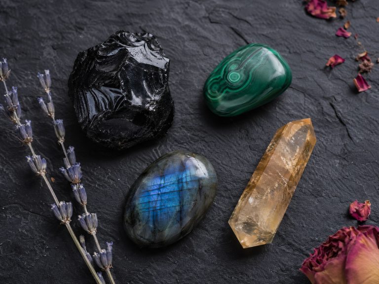 A Raw Black Obsidian Piece, A Tumbled Malachite, A Polished Labradorite Cabochon Showing Blue Flash, And A Citrine Point