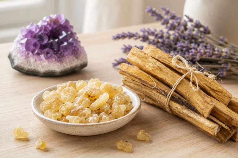 Amber resin, lavender sprigs, and amethyst crystal for aromatherapy and relaxation.