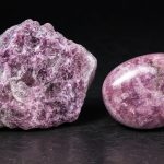 Raw and tumbled lepidolite specimens showing pink-violet lithium mica on a dark background